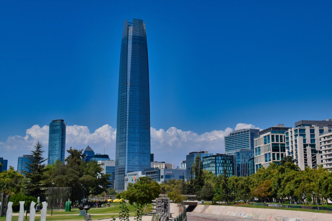 Skyline of Santiago, Chile, featuring the modern Gran Torre Santiago skyscraper against the backdrop of the Andes Mountains.