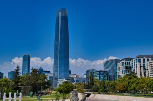 Skyline of Santiago, Chile, featuring the modern Gran Torre Santiago skyscraper against the backdrop of the Andes Mountains.