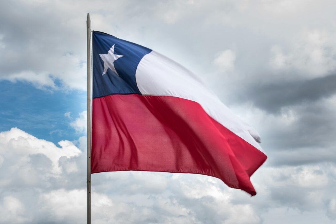 Is Santiago Chile Worth Visiting — Chilean flag waving against a clear sky, representing the culture and travel appeal of Santiago, Chile.