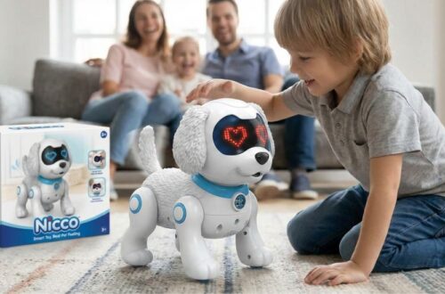 A white and blue Nicco robot puppy with glowing red heart-shaped LED eyes being petted by a young boy on a living room rug, with the product box visible in the background.