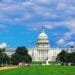 Things to Do in Washington, DC With Kids: The majestic United States Capitol building surrounded by lush green lawns and colorful food trucks under a bright blue sky with fluffy white clouds.