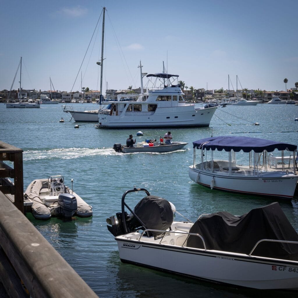 Boats and yachts docked in the harbor highlight leisure things to do in Newport Beach.