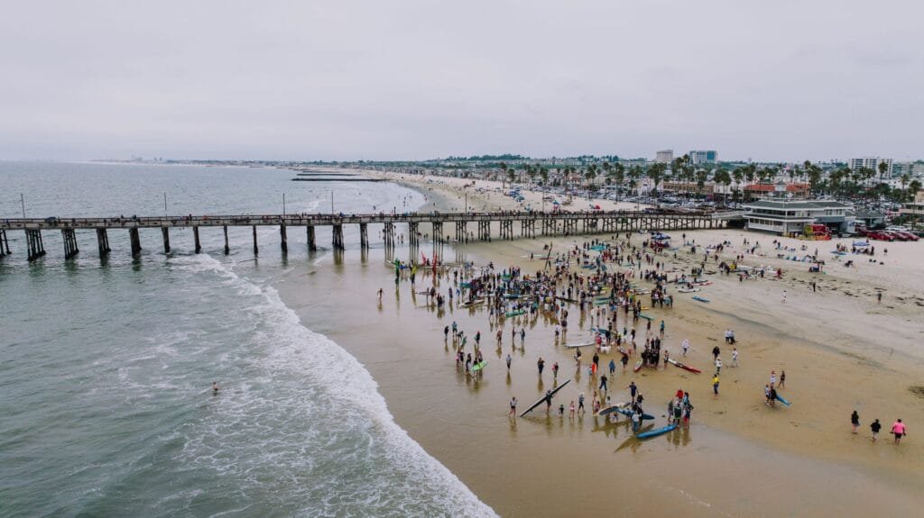 Crowd gathered near Newport Beach pier for top local things to do in Newport Beach.