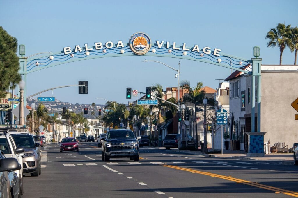 Iconic entry arch sign for Balboa Village showcasing popular family.